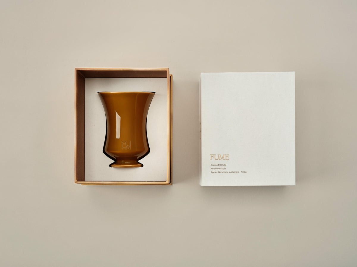 Open Ambered Apple candle box beside its closed twin box, showing the candle nested in its packaging