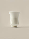 Cream ceramic Fume candle vessel on a beige background