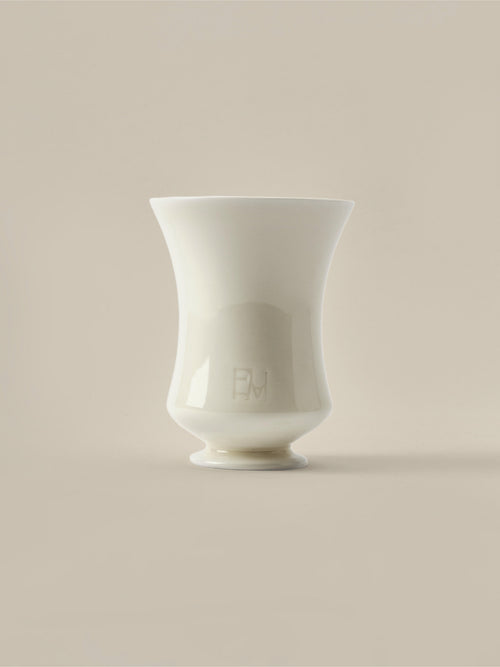 Cream ceramic Fume candle vessel on a beige background