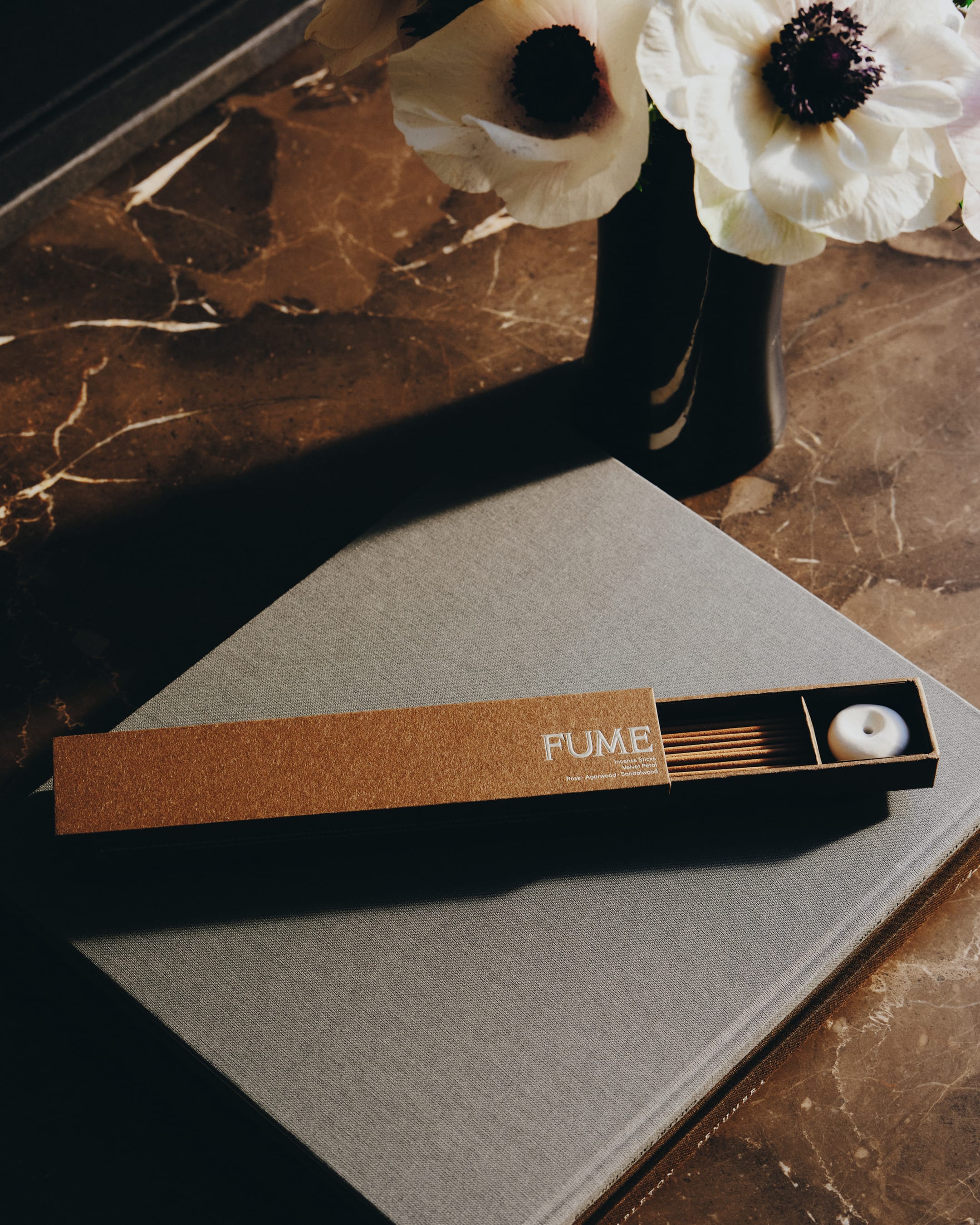 Fume incense set with packaging on a marble surface